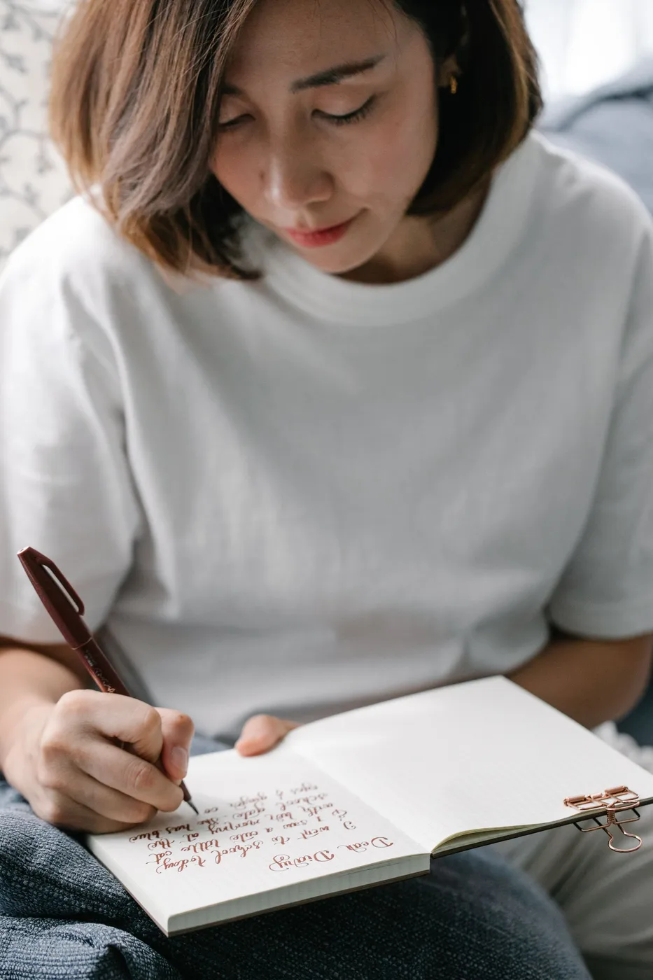 Mulher escrevendo em um diário, praticando autocuidado
